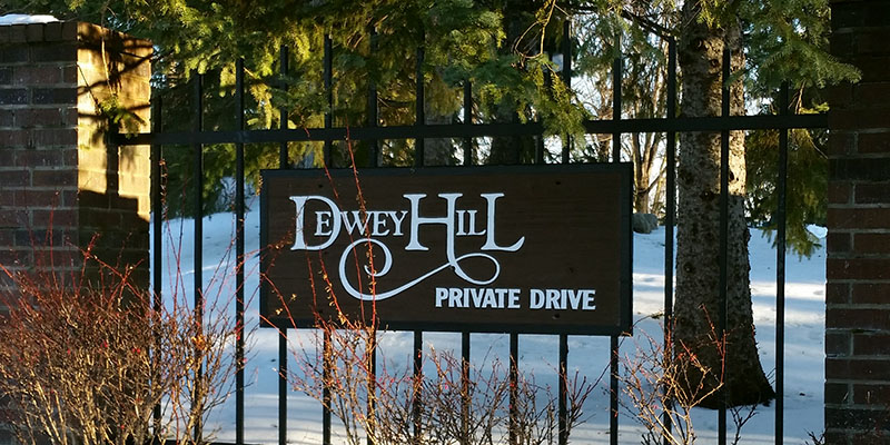 An entrance sign reading Dewey Hill Private Drive.