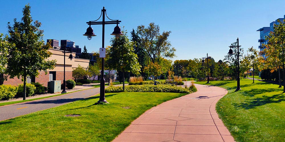 Walking paths and landscaping along the Edina Promenade.