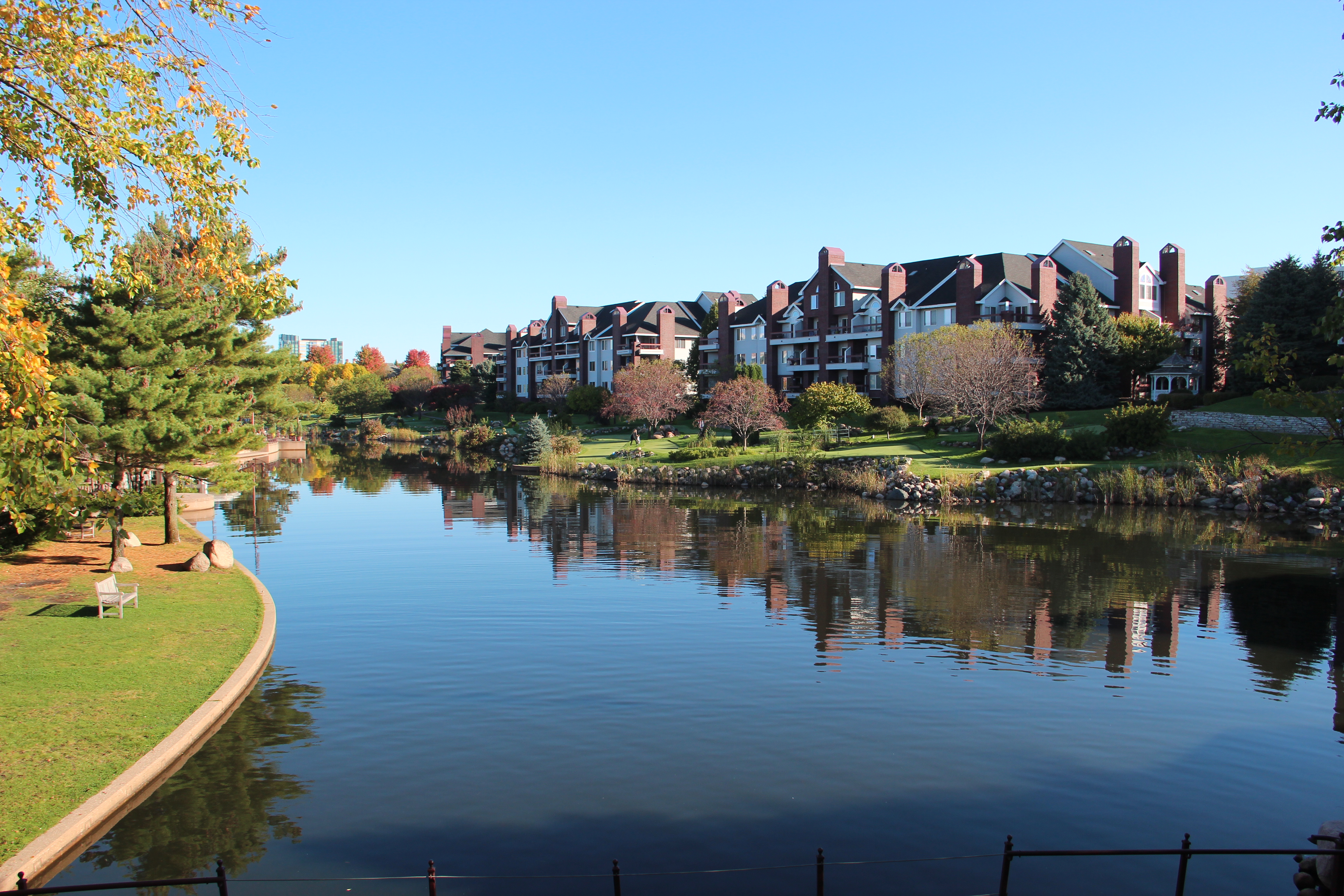 Centennial Lakes Park in autumn, with homes reflected in the water.